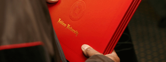 hands holding an IU South Bend diploma