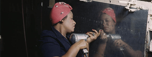 Woman working on plane during WW II